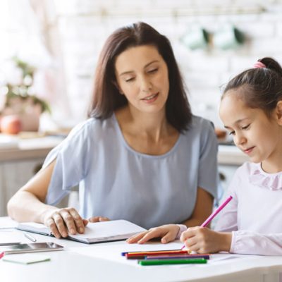 beautiful-mother-helping-her-daughter-with-homewor-BELMZW4.jpg